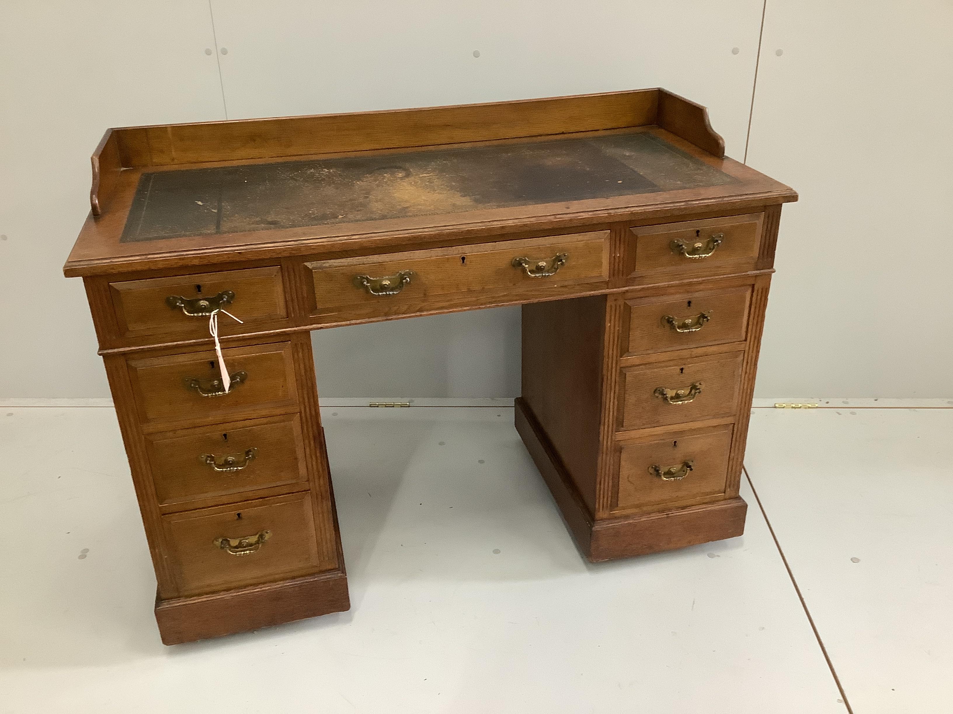 A late Victorian oak pedestal desk, width 114cm, depth 53cm, height 84cm